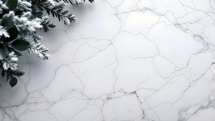 A clean, white marble surface with fine gray veining, featuring a corner of frosted pine or evergreen branches. Elegant winter and Christmas background