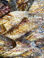 Deep fried Snakeskin gourami fish with spawns on white arches oil paper sheet