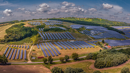 A vast solar power plant on the hillside captures sunlight to generate clean, renewable electricity. Solar energy is essential for a green future and global sustainability.