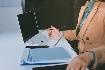 Close-up of businessman's hands making notes, mobiles, chart, desk, office