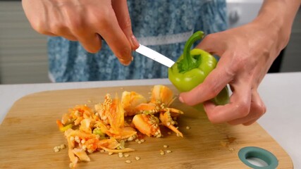 Woman hands cutting removing seeds from green bell pepper cooking on kitchen. Culinary techniques, homemade preparing healthy meal, cook food dish, domestic cuisine. Vegetables organic products.