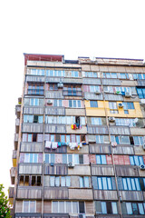 High-rise Soviet-era apartment block in Yerevan, Armenia, showcasing weathered facades, colorful balconies, air conditioning units, and laundry hanging on clotheslines