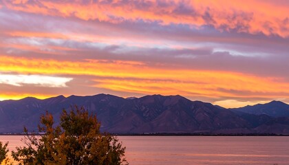 Colorful sunset over mountains and lake