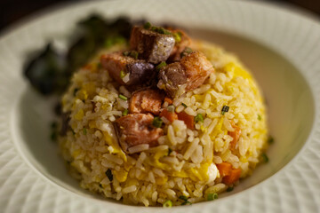 Plate Of Salmon Fried Rice On Rustic Wooden Table