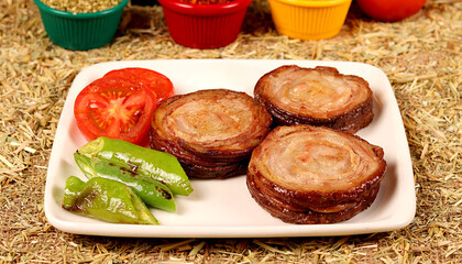 3 kokorech on a white plate, cut into one portion