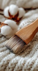 Fototapeta premium Close-up of wooden brush on knitted fabric with cotton