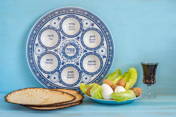 Jewish holiday Pesach or Passover background with Seder Plate and symbolic food eggs, lettuce,...