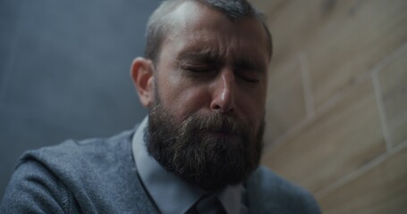 Fototapeta premium Businessman Suffering from Diarrhea and Indigestion, Sitting on the Toilet. Man Experiencing Abdominal Pain, Stomach Upset and Digestive Discomfort in Modern Office Restroom During Work. Close Up.
