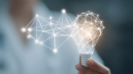 Hand holding a light bulb with a glowing network structure symbolizing innovation and connectivity