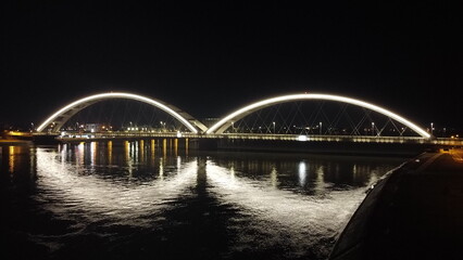 Illuminated Modern Bridge Over the River at Night. Novi Sad, Serbia, 1.16.2024