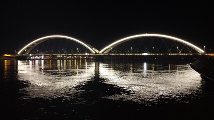 Illuminated Modern Bridge Over the River at Night. Novi Sad, Serbia, 1.16.2024