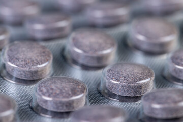 whole purple tablets packed in a metal-plastic blister with the addition of blueberry extract and other ingredients