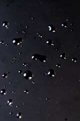 wet black film on the screen , transparent protective soft film glued to the touch screen of a modern device covered with water droplets