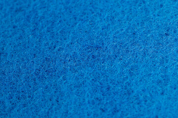 the fabric for washing large dirt on objects, glued and tightly intertwined blue synthetic threads on a sponge that is used for cleaning and washing