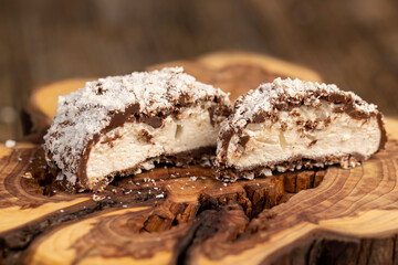 cut marshmallows in chocolate with coconut chips, sweet dessert marshmallows in milk chocolate with coconut cut in half