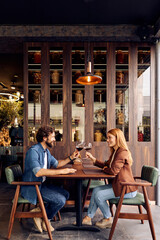 Couple Enjoying Wine Together at a Stylish Restaurant Setting