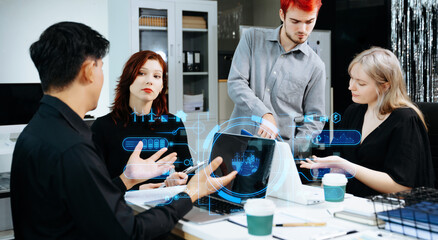 Business team collaborating with futuristic digital overlays on renewable energy, eco solutions, and innovation, symbolizing technology, teamwork, and sustainability.