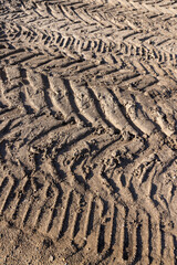 car tracks in the field, deep tracks from the large tread of very heavy vehicles in the field after harvesting