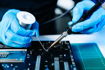 The technician repairing the motherboard in the lab with copy space. the concept of computer...