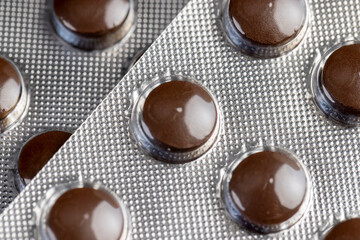 brown tablets in a blister to ensure the safety of the medicine, several blisters with brown tablets