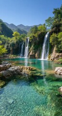 Obraz premium Serene tiered waterfalls cascade into a crystal-clear turquoise pool, nestled within a lush green mountain valley under a vibrant blue sky