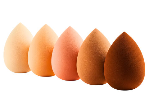 Set of teardrop makeup sponges in a gradient of skin tone shades on a transparent background