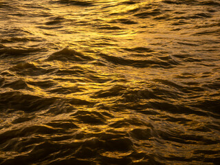 Golden Ocean Water Waves Surface Reflection at Sunset - Abstract Shimmering Sea Texture Background Pattern
