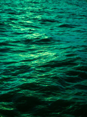 Turquoise Green Ocean Water Waves Surface with Golden Light Reflection - Tropical Sea Texture Background Pattern