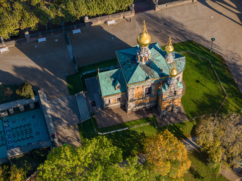 Aerial view of the Russian Chapel with its gilded domes gleams, a striking contrast against the lush green landscape, Mathildenh&Atilde;&para;he, Darmstadt, Hessen, Germany.