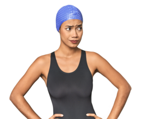 Pro Latina swimmer in studio gear confused, feels doubtful and unsure.