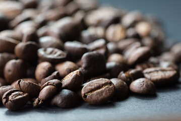 coffee in white cup and coffee beans are the background.