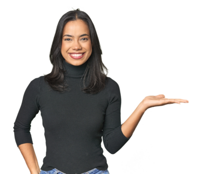 Simple portrait of a young Latina showing a copy space on a palm and holding another hand on waist.