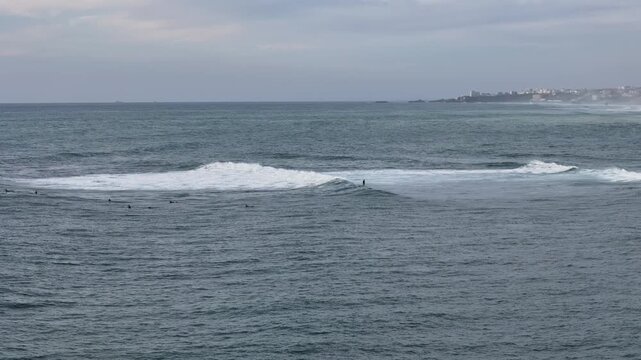 Surfers enjoying big waves at the basque coast between Getaria and Bidarte, at the Basque Country.