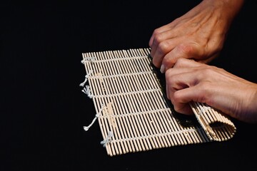 hand of a man...
Sushi Roll on Bamboo Mat &ndash; The Art of Sushi Rolling