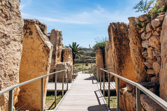 Ancient megalithic Ġgantija Temples, a UNESCO World Heritage site on Xagħra plateau, featuring massive limestone blocks and original Neolithic stone architecture under a clear spring sky