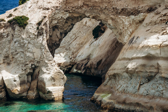 Scenic Munxar Window limestone rock arch rising above the turquoise Mediterranean Sea, Marsaskala, Malta