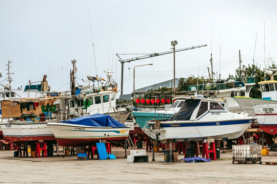 Marsaxlokk, Malta - April 13, 2025: Fishing boats on dry dock undergoing maintenance, including the bright blue vessel Roberta Valletta, at the shipyard in the traditional Maltese fishing village of M