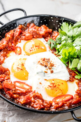 Classic shakshuka with baked eggs and parsley.