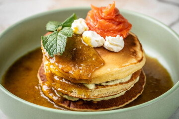 Savory pancakes with smoked salmon and avocado cream.