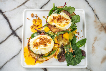 A modern and delicious plate of classic Eggs Benedict.