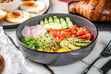 A fresh and healthy gourmet bowl with avocado and colorful vegetables.