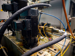 Industrial machinery with hydraulic components illuminated in a factory setting