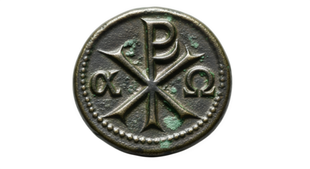 Closeup of an ancient bronze coin featuring the chirho symbol, a christian symbol, along with the greek letters alpha and omega isolated on transparent background