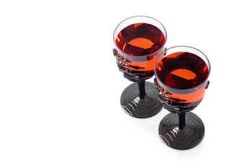 Halloween spooky red cocktail in skeleton hand glass isolated on white background. Copy space