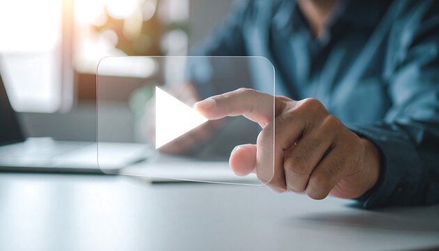 Transparent glass play button icon tapped by businessman hand for technology innovation