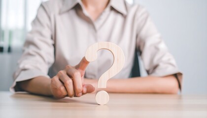 Businesswoman hand touching wooden question mark icon concept of problem solving and decision making