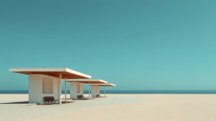 Fototapeta premium Tranquil Beach Scene with Modern Shelters Under Clear Blue Sky Perfect for Relaxation and Leisure Activities