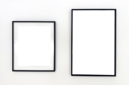 Two empty black photo frames of different sizes hanging on a white wall. Minimalist mockup for