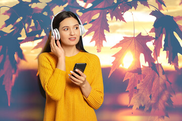 Woman listening to sounds of nature which making her feel calm. Tree branch with leaves on background