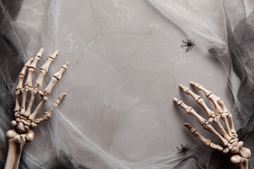 Halloween background with skeleton hands at bottom, top blank space